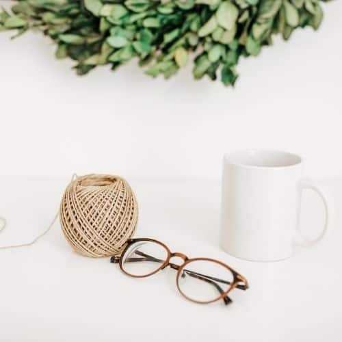 Lifestyle image of crochet yarn glasses and coffee mug Home